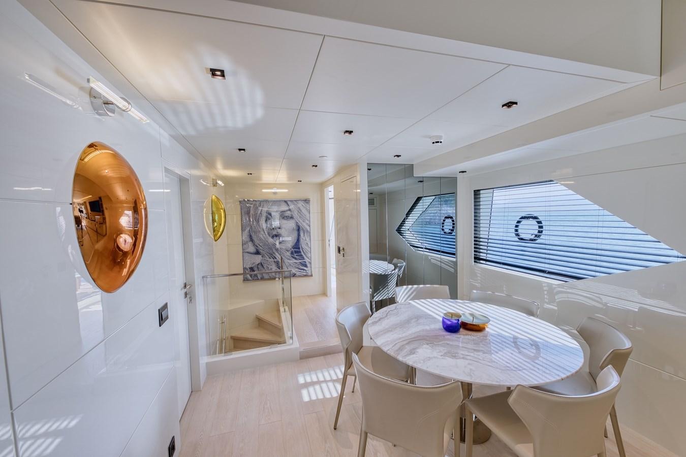 a room with a table and chairs aboard ROCK X Yacht for Sale