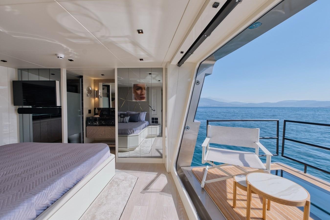 a boat with a bed and a table on it aboard ROCK X Yacht for Sale
