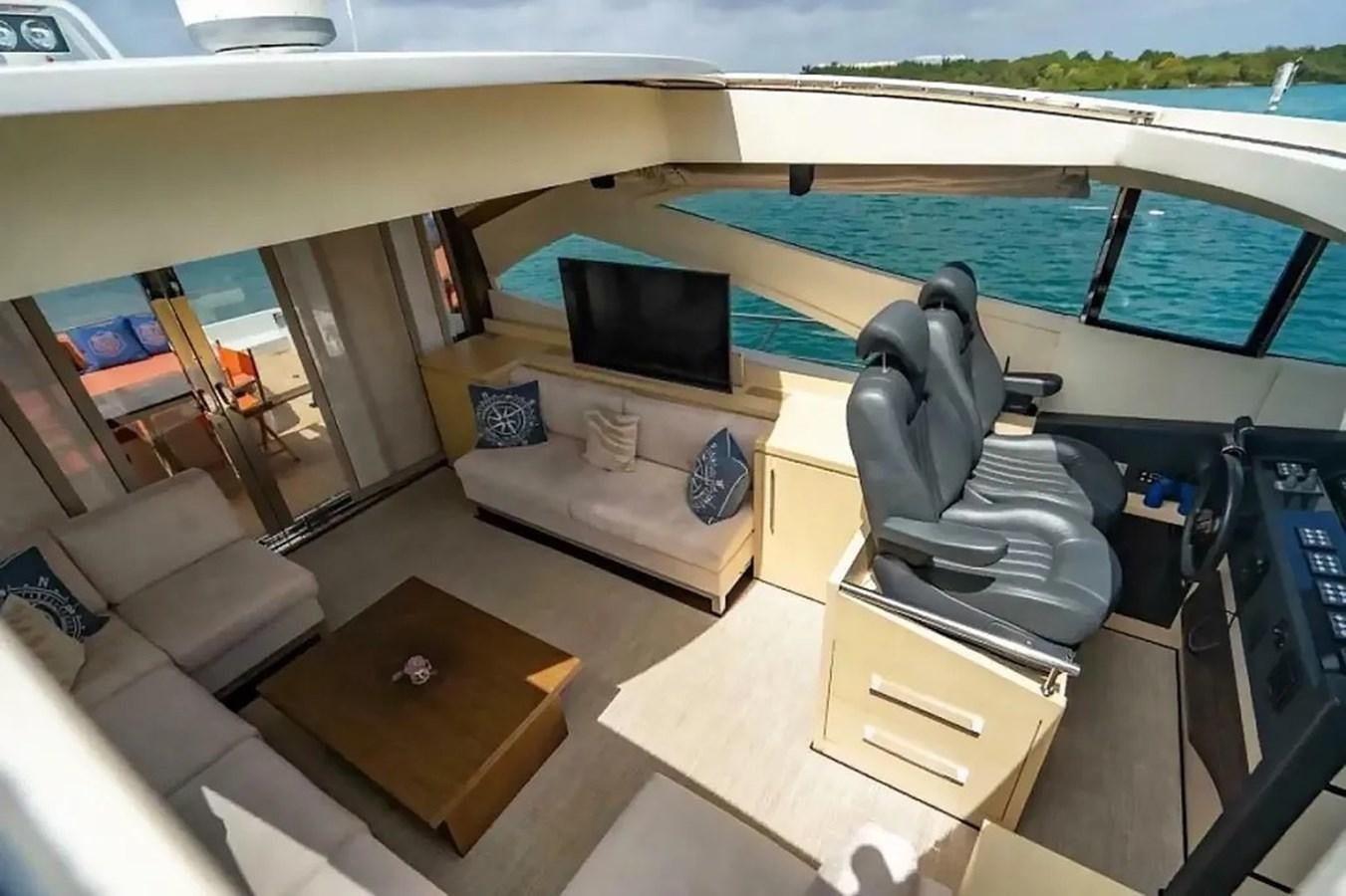 a room with a chair and a desk and a television aboard BELLA VITA Yacht for Sale