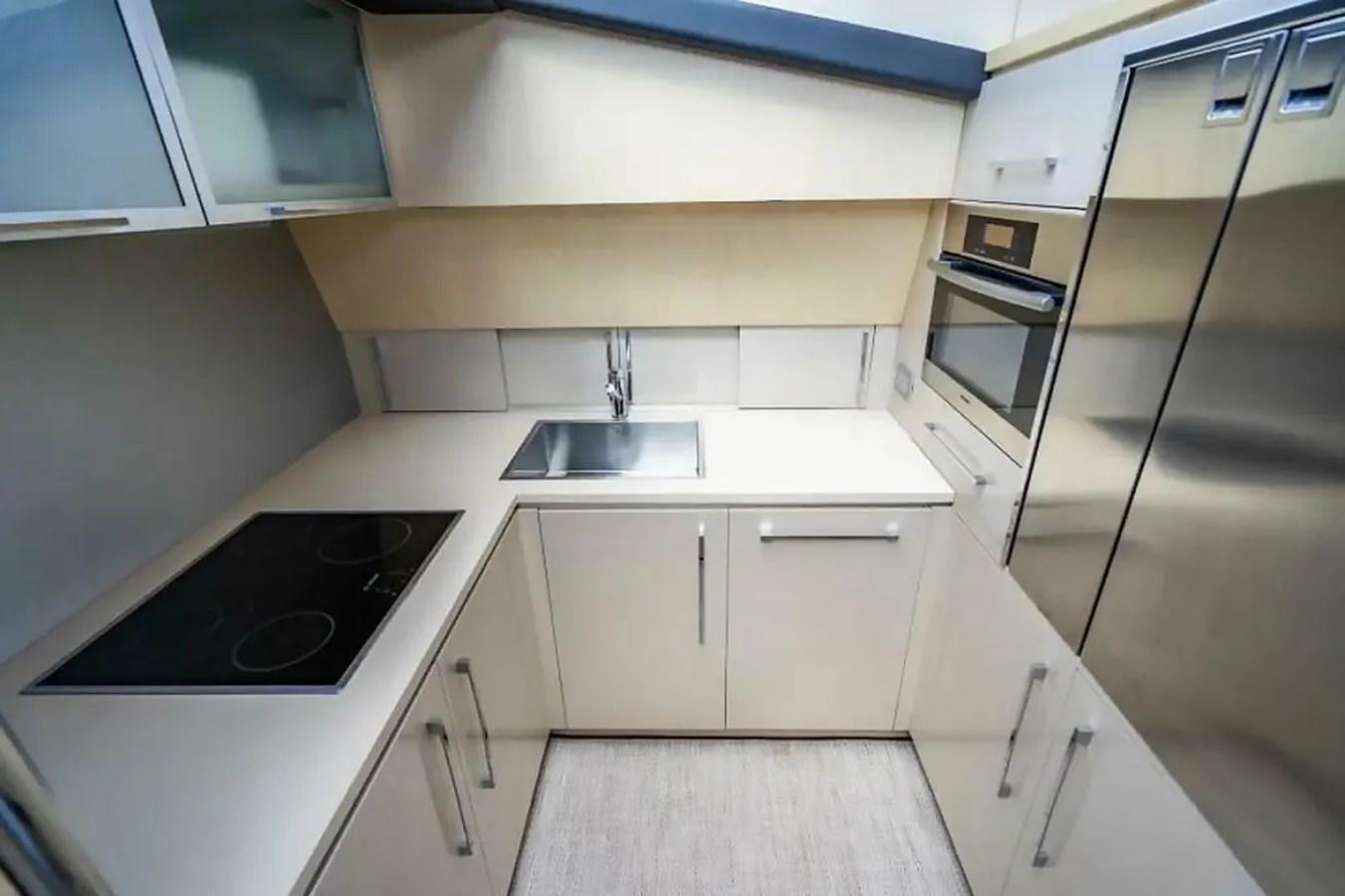 a kitchen with white cabinets aboard BELLA VITA Yacht for Sale