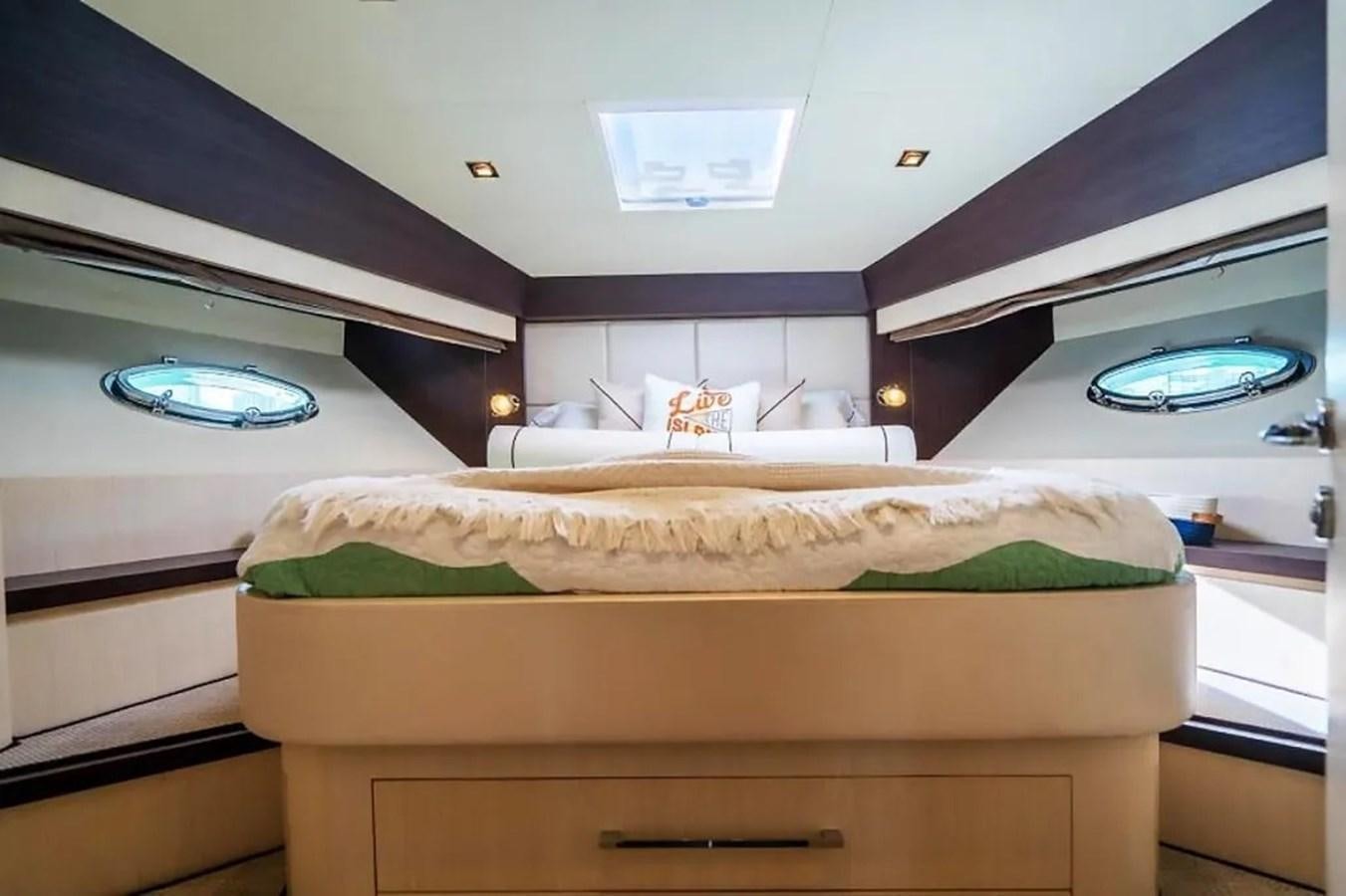 a bedroom with a bed and a desk aboard BELLA VITA Yacht for Sale