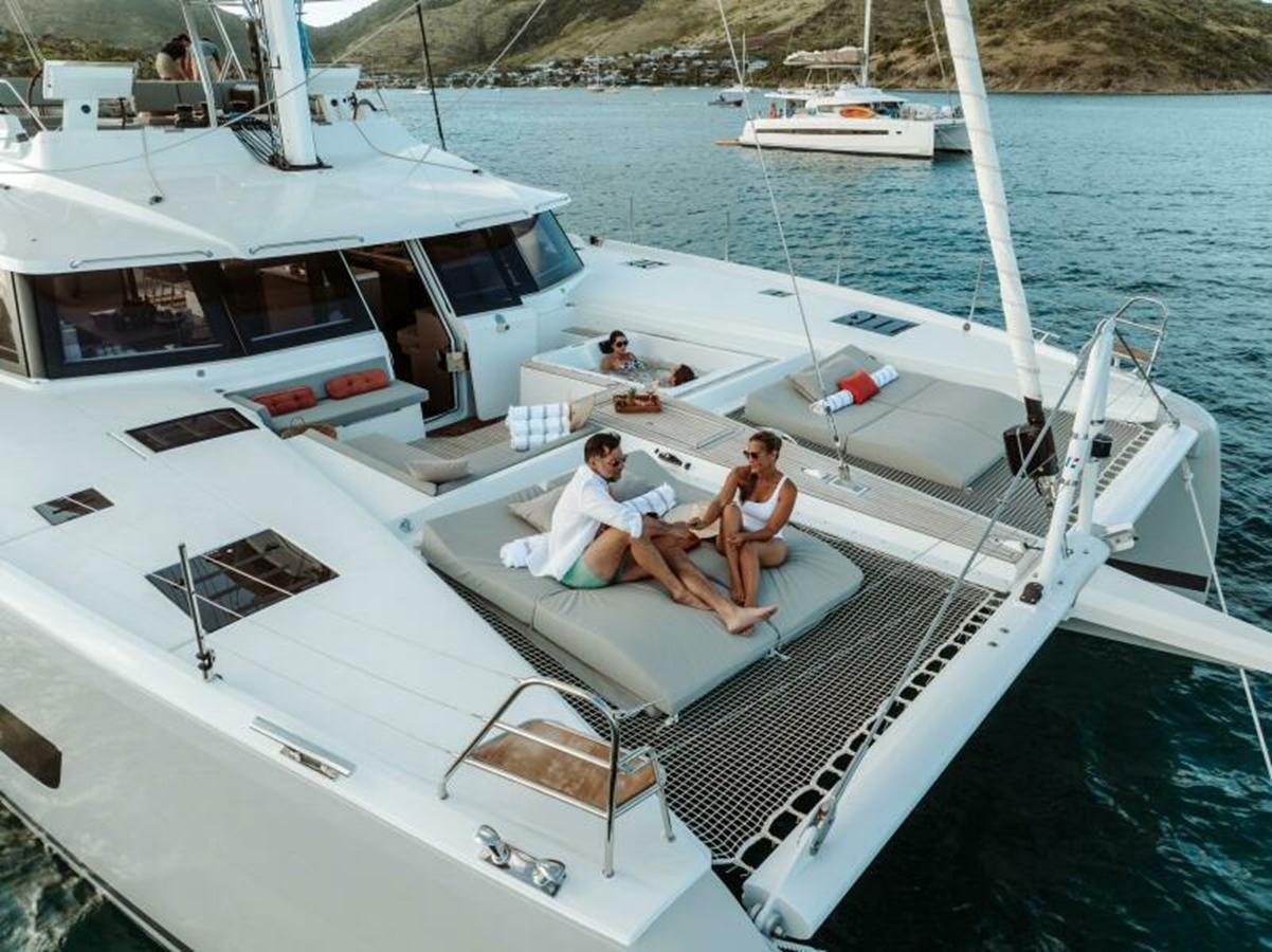 a couple of people sitting on a boat in the water aboard 2022 FOUNTAINE PAJOT POWER 67 Yacht for Sale