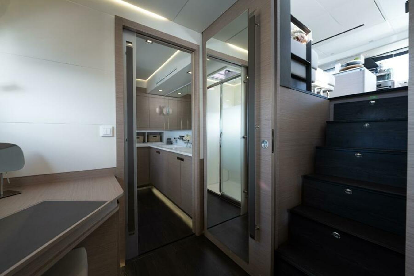 a room with a door and a mirror aboard 2022 FOUNTAINE PAJOT POWER 67 Yacht for Sale