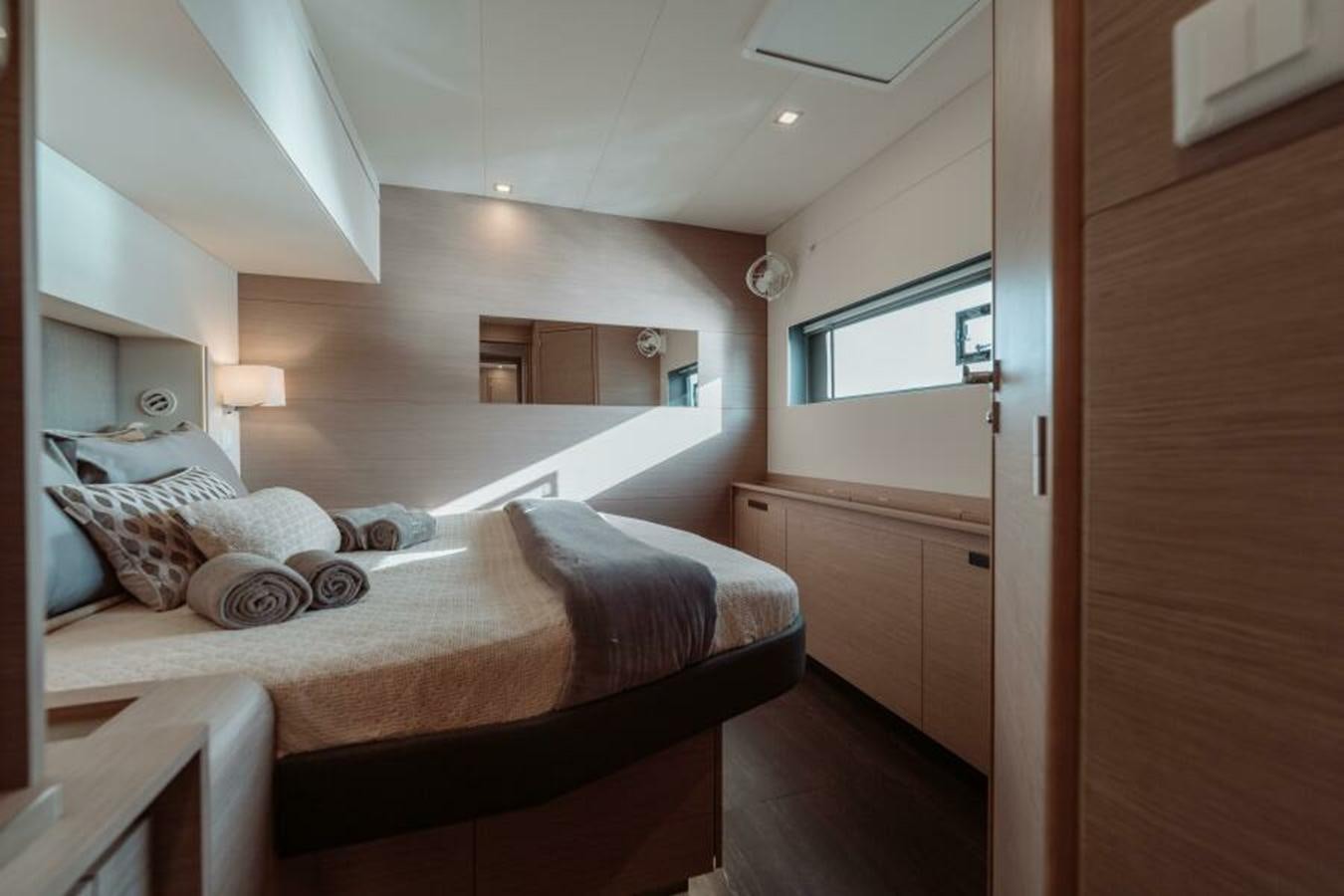a bedroom with a bed and a mirror aboard 2022 FOUNTAINE PAJOT POWER 67 Yacht for Sale
