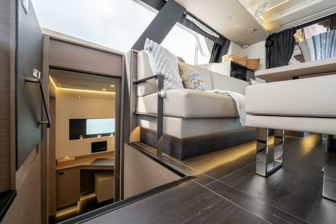 a room with a bed and desk aboard 2022 FOUNTAINE PAJOT POWER 67 Yacht for Sale