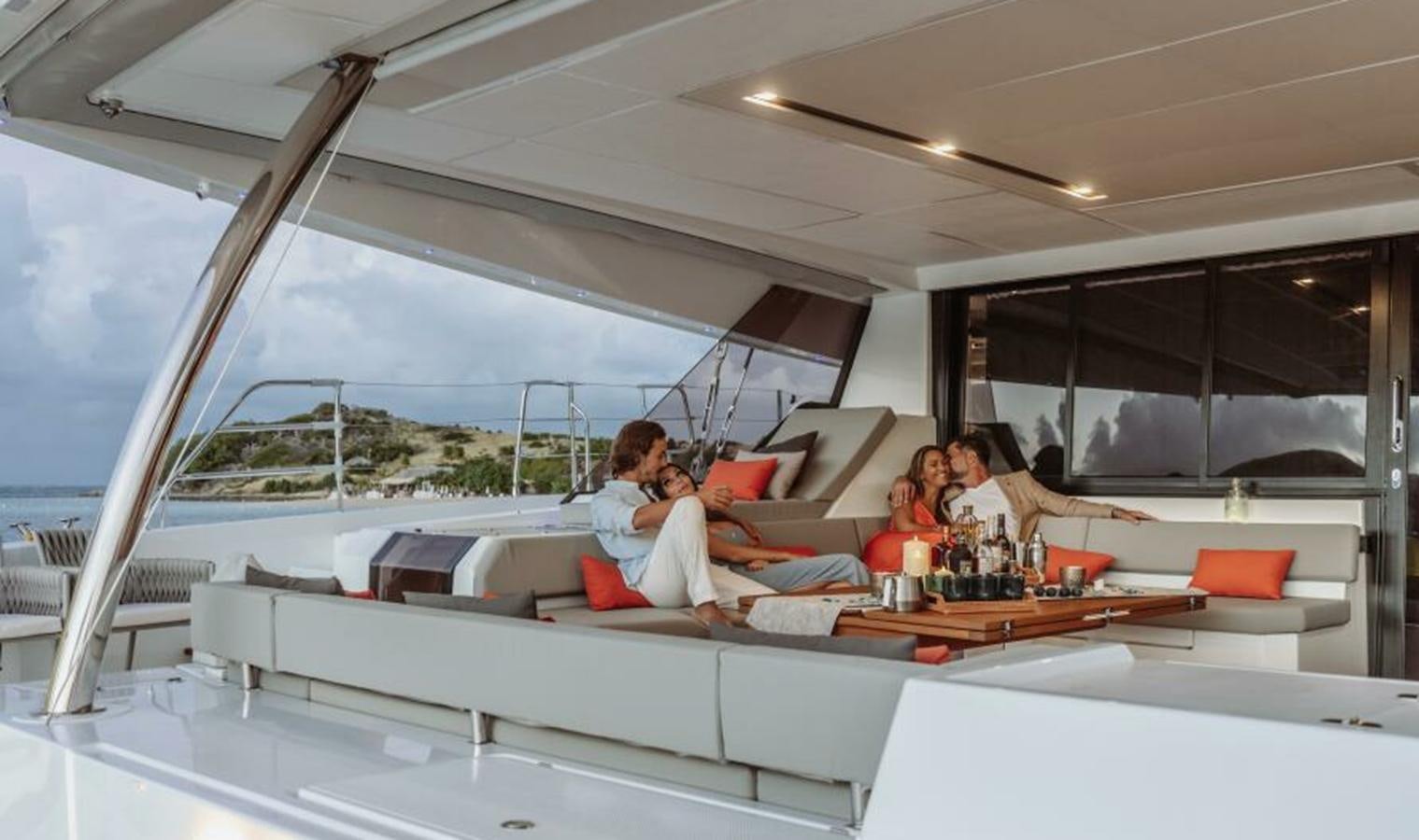 people sitting at a table aboard 2022 FOUNTAINE PAJOT POWER 67 Yacht for Sale