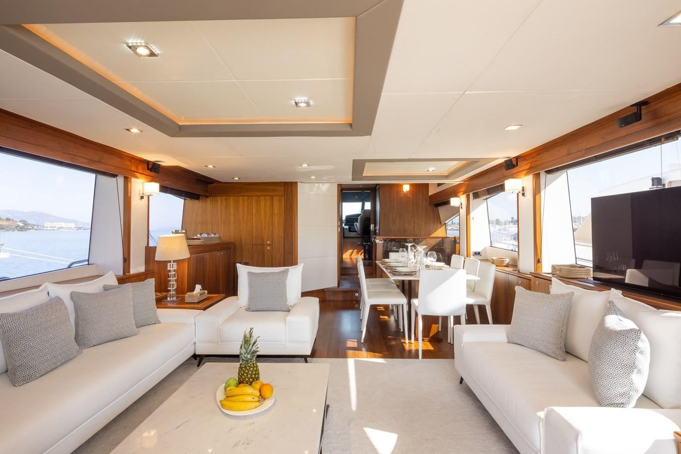 a living room with a couch and a television aboard SHINE R Yacht for Sale