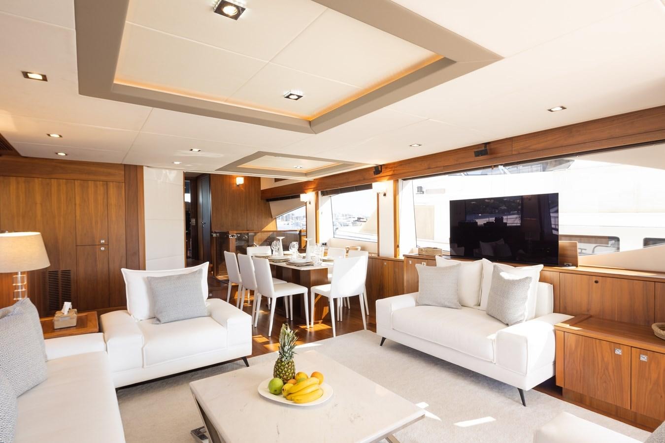 a living room with a large screen aboard SHINE R Yacht for Sale