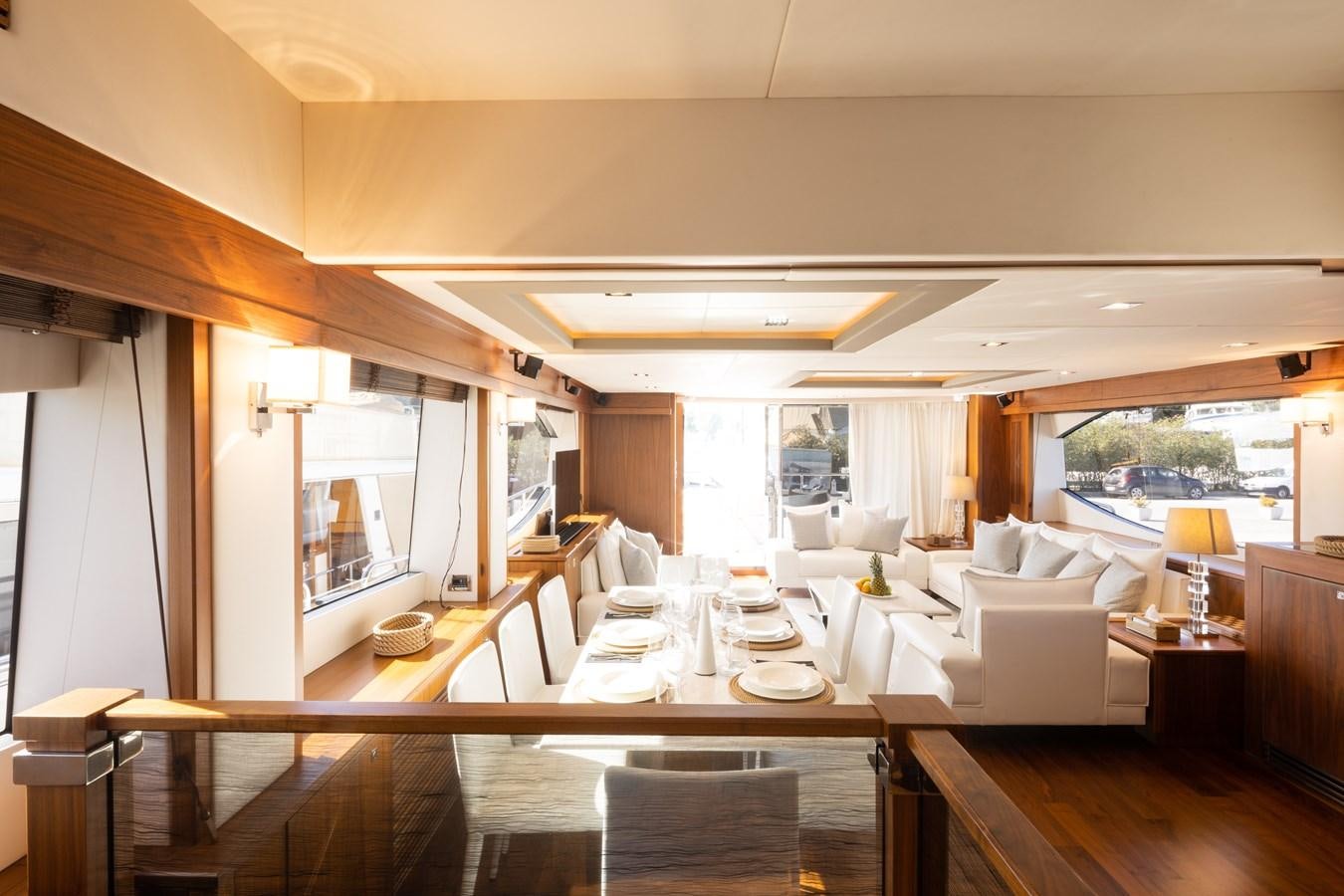 a large living room with a large table and chairs aboard SHINE R Yacht for Sale
