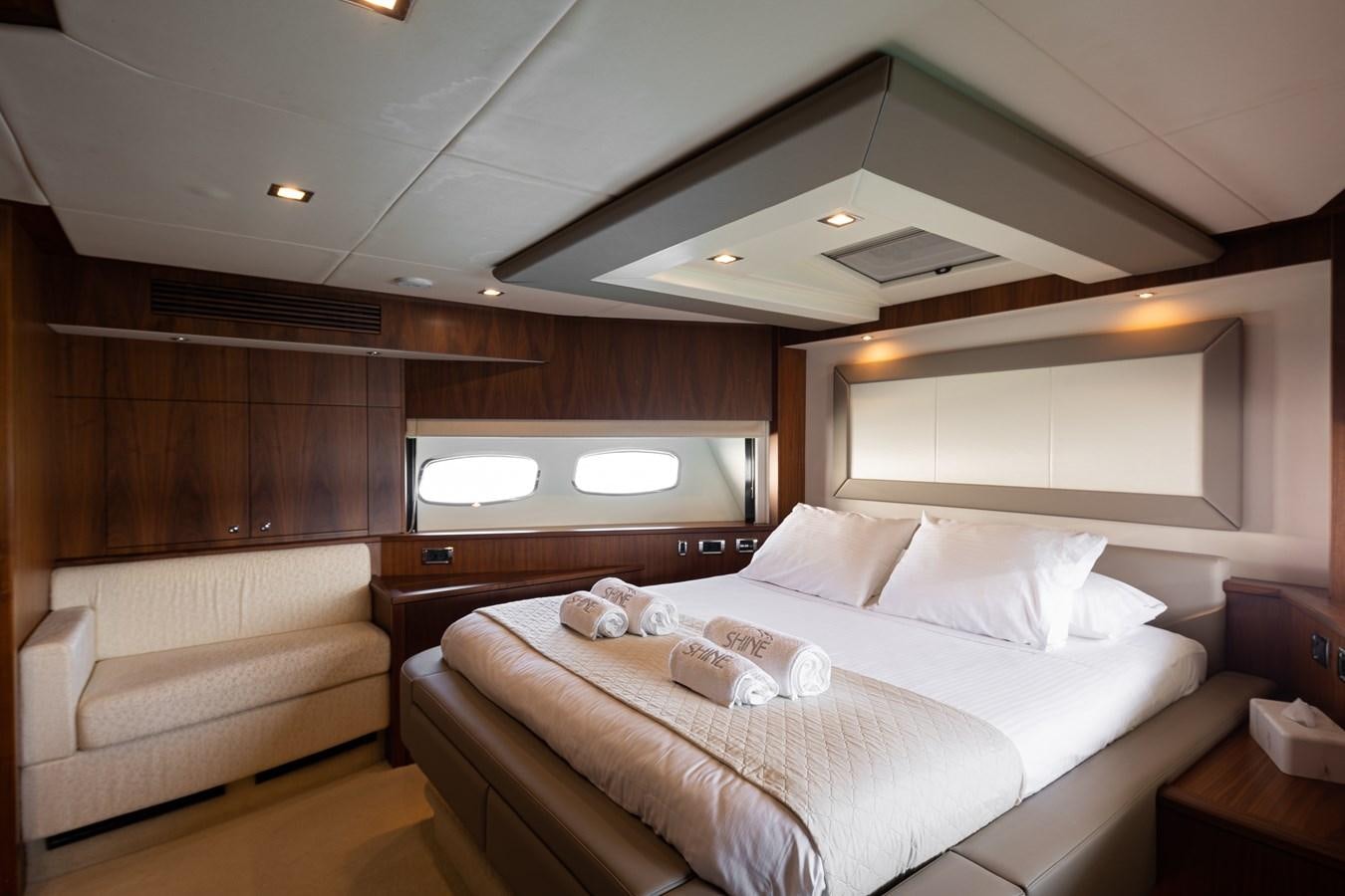 a room with a bed and a couch aboard SHINE R Yacht for Sale