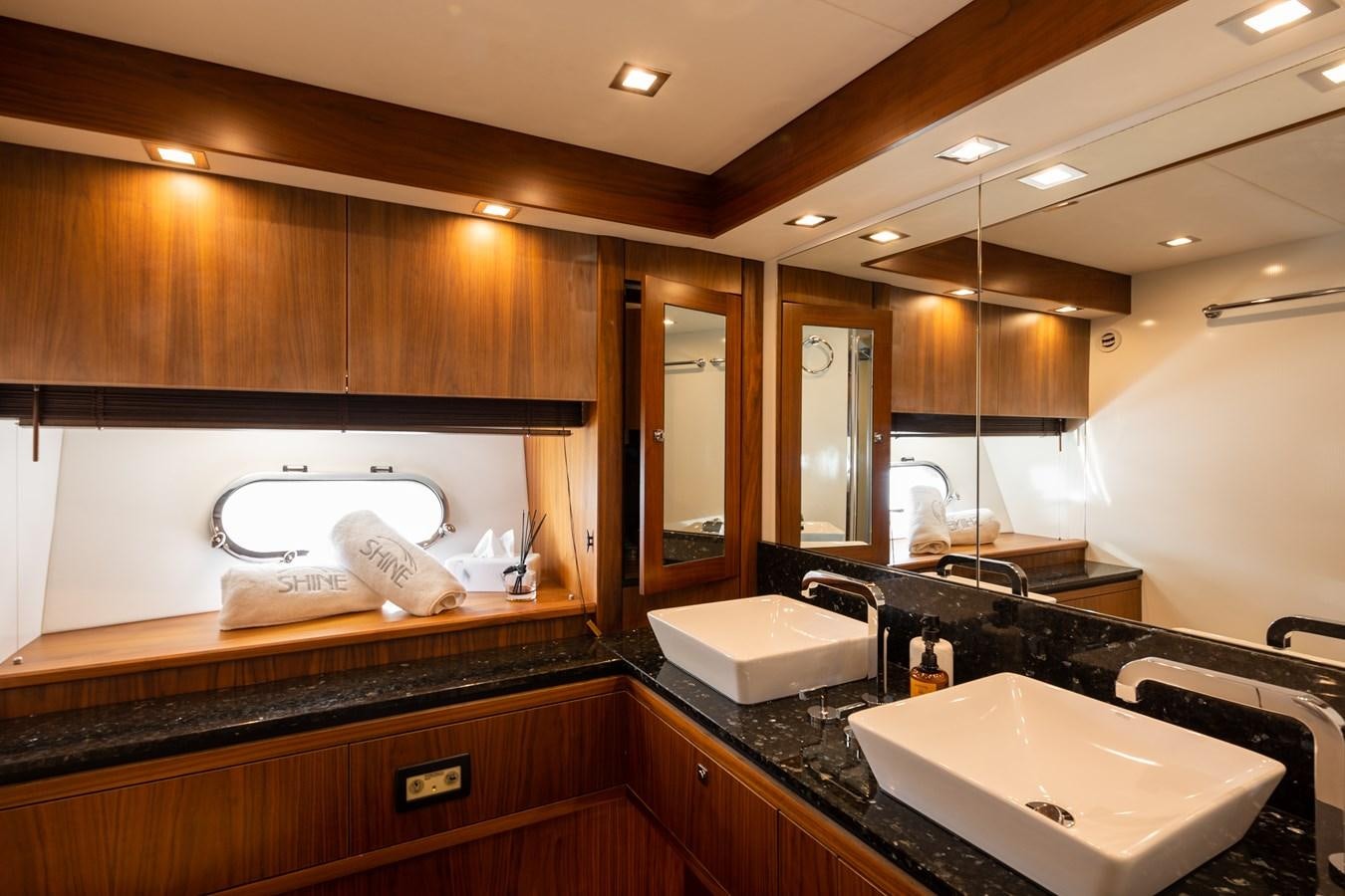 a bathroom with a large mirror aboard SHINE R Yacht for Sale