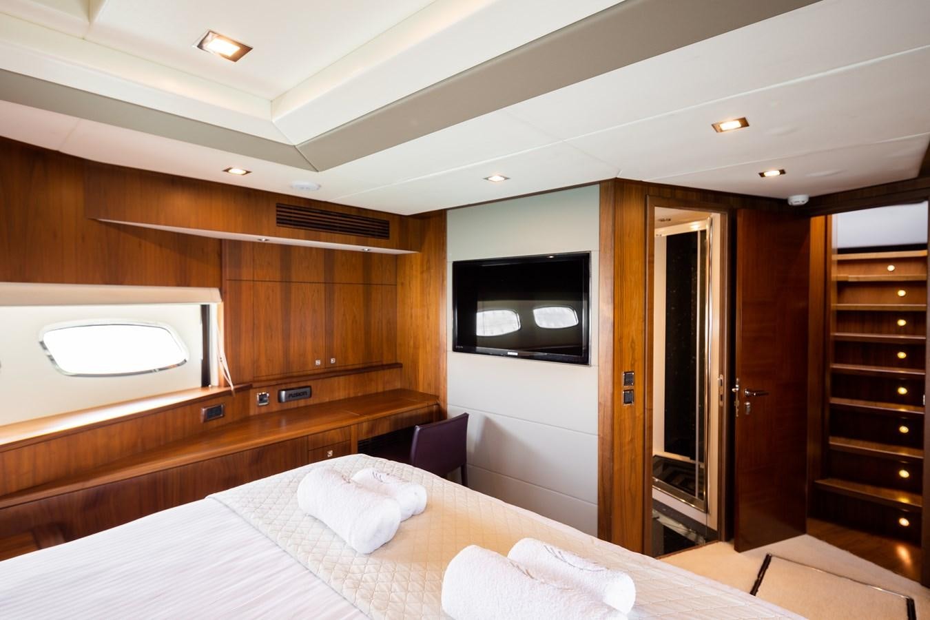 a room with a bed and a television aboard SHINE R Yacht for Sale