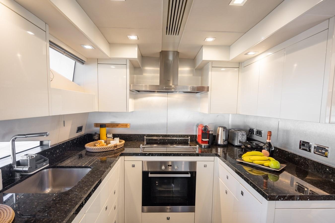 a kitchen with white cabinets aboard SHINE R Yacht for Sale
