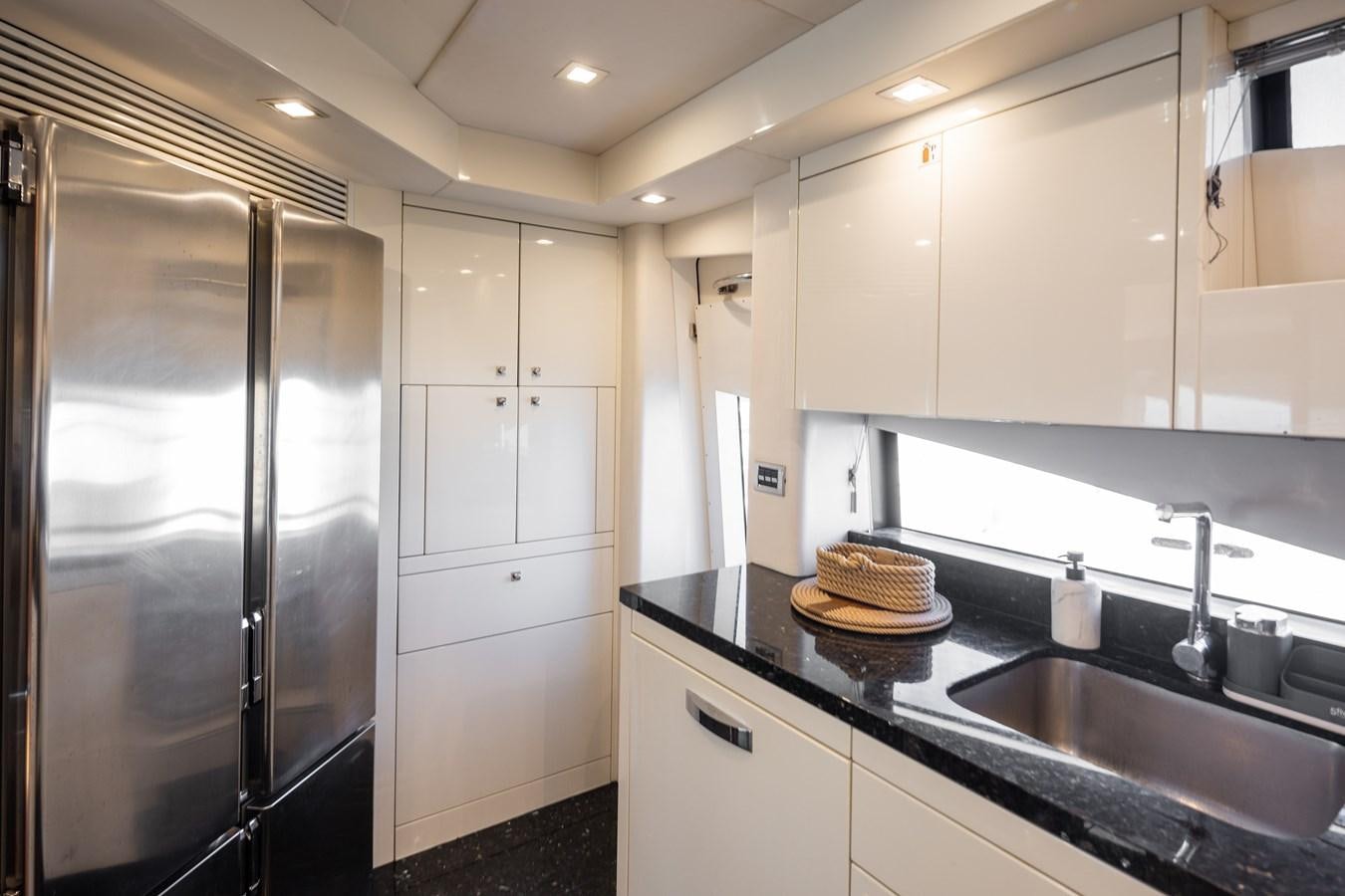 a kitchen with white cabinets aboard SHINE R Yacht for Sale