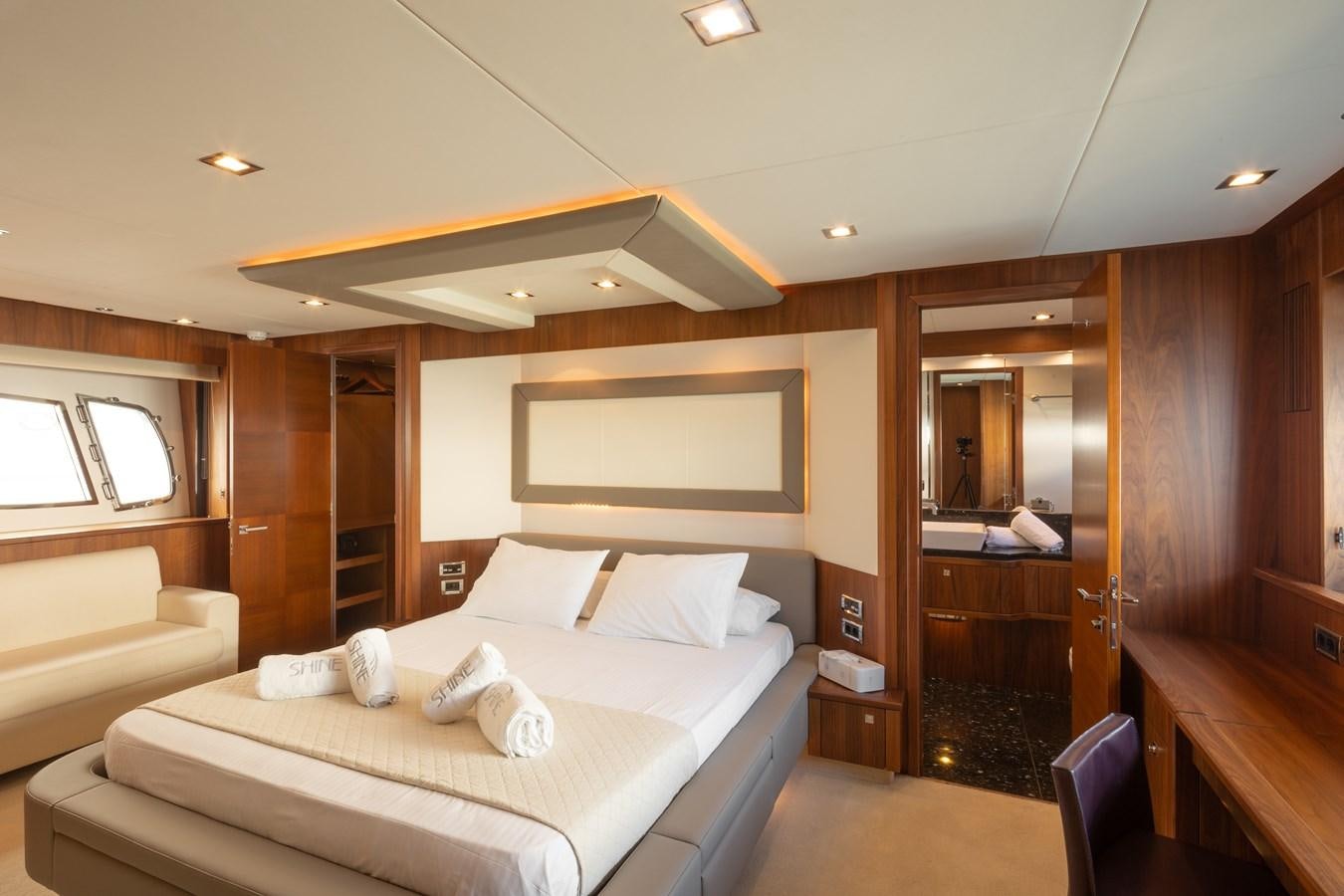 a bedroom with a bed and a tv on the wall aboard SHINE R Yacht for Sale