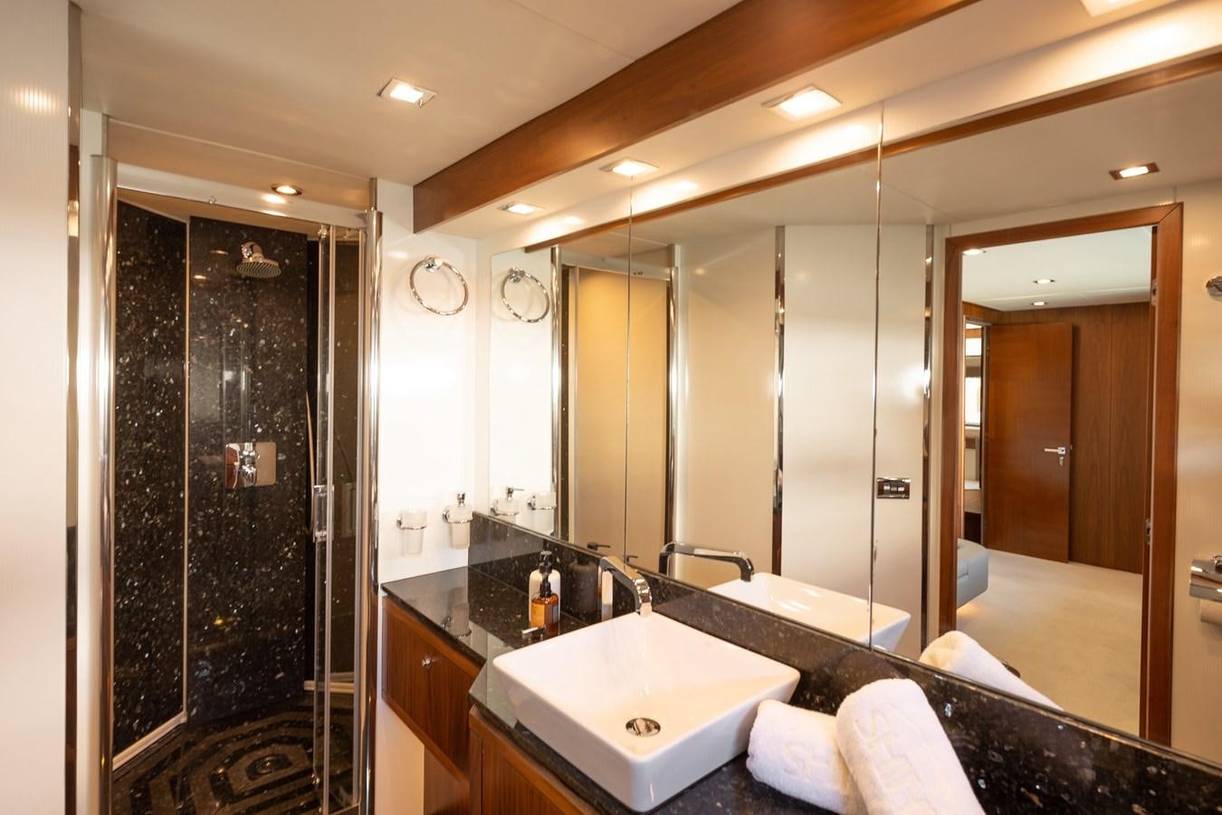 a bathroom with a large mirror aboard SHINE R Yacht for Sale