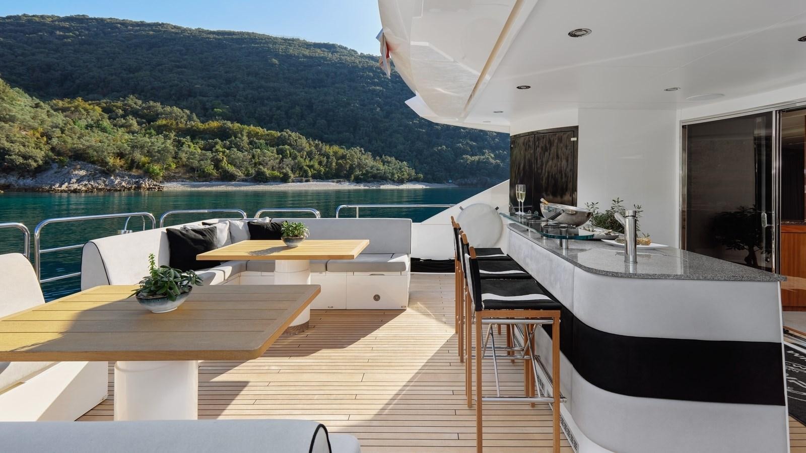 a room with a table and chairs aboard WICKED PLAY Yacht for Sale
