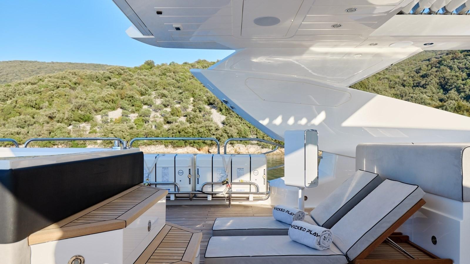 a room with a balcony and a view of a mountain aboard WICKED PLAY Yacht for Sale