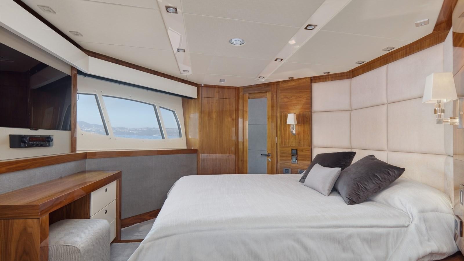 a room with a bed and a television aboard WICKED PLAY Yacht for Sale