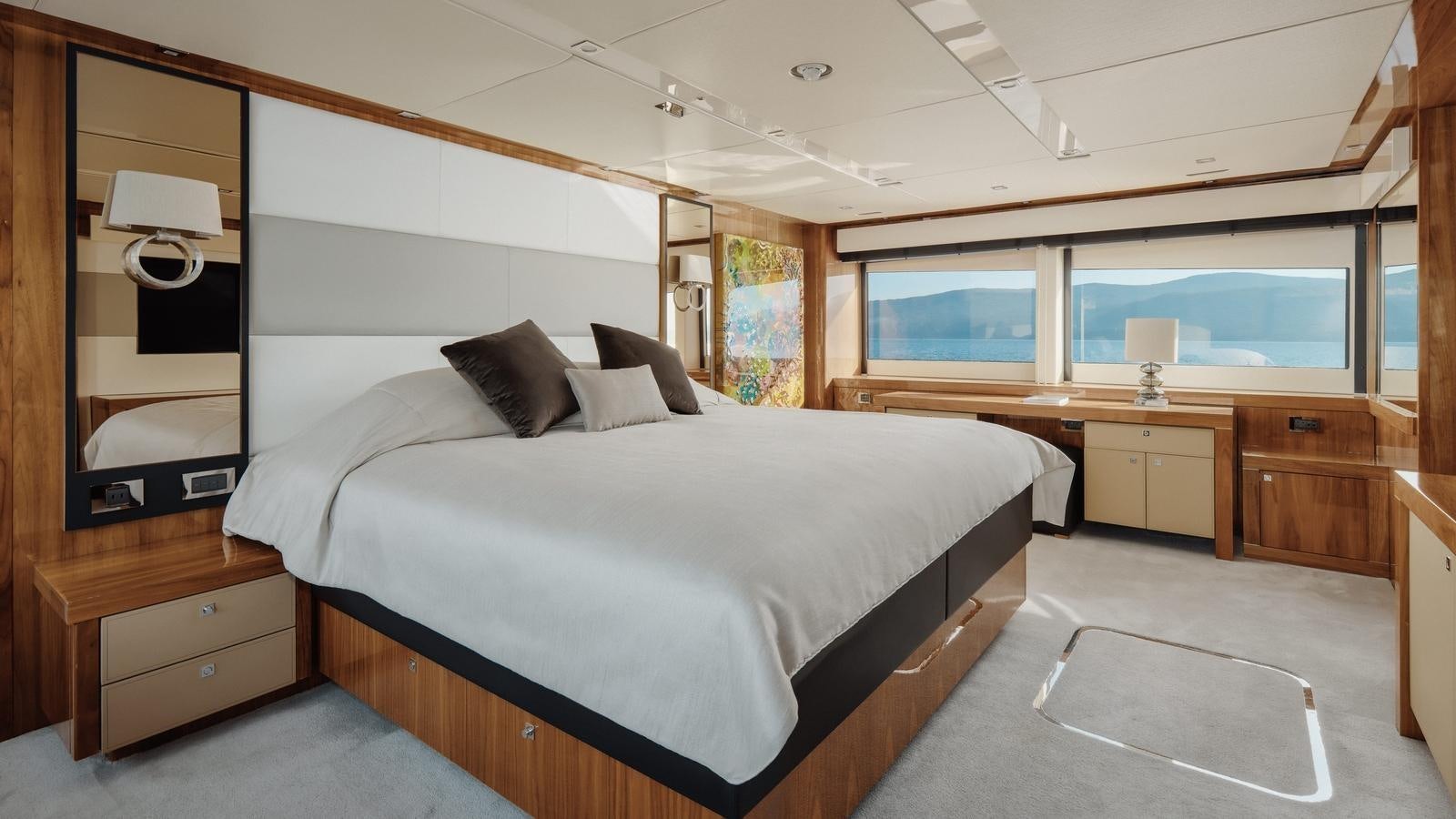 a bedroom with a bed and a desk aboard WICKED PLAY Yacht for Sale