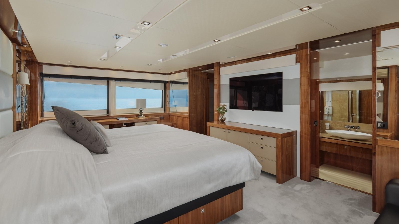a bedroom with a large bed aboard WICKED PLAY Yacht for Sale