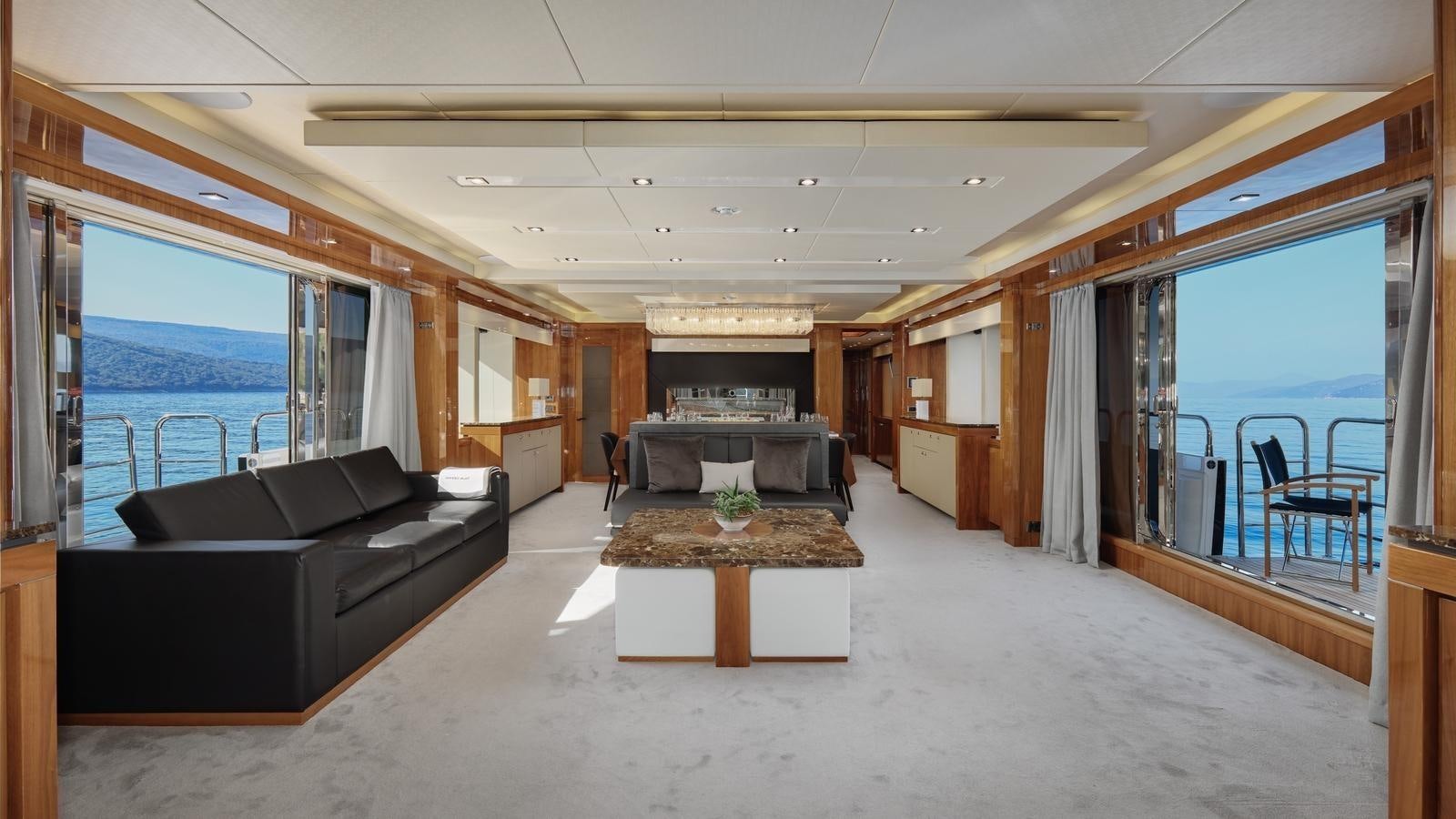 a living room with a large window aboard WICKED PLAY Yacht for Sale