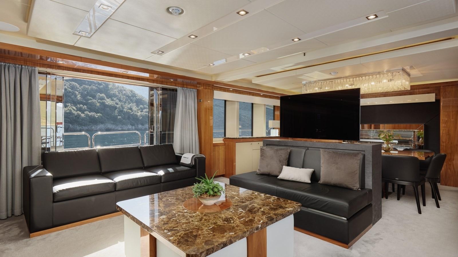 a living room with a large screen aboard WICKED PLAY Yacht for Sale
