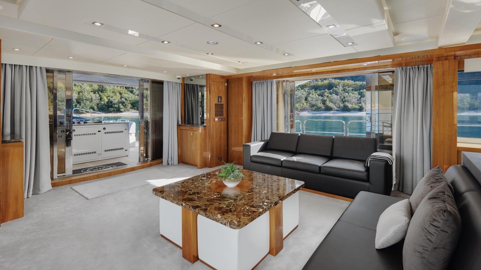 a living room with a large window aboard WICKED PLAY Yacht for Sale