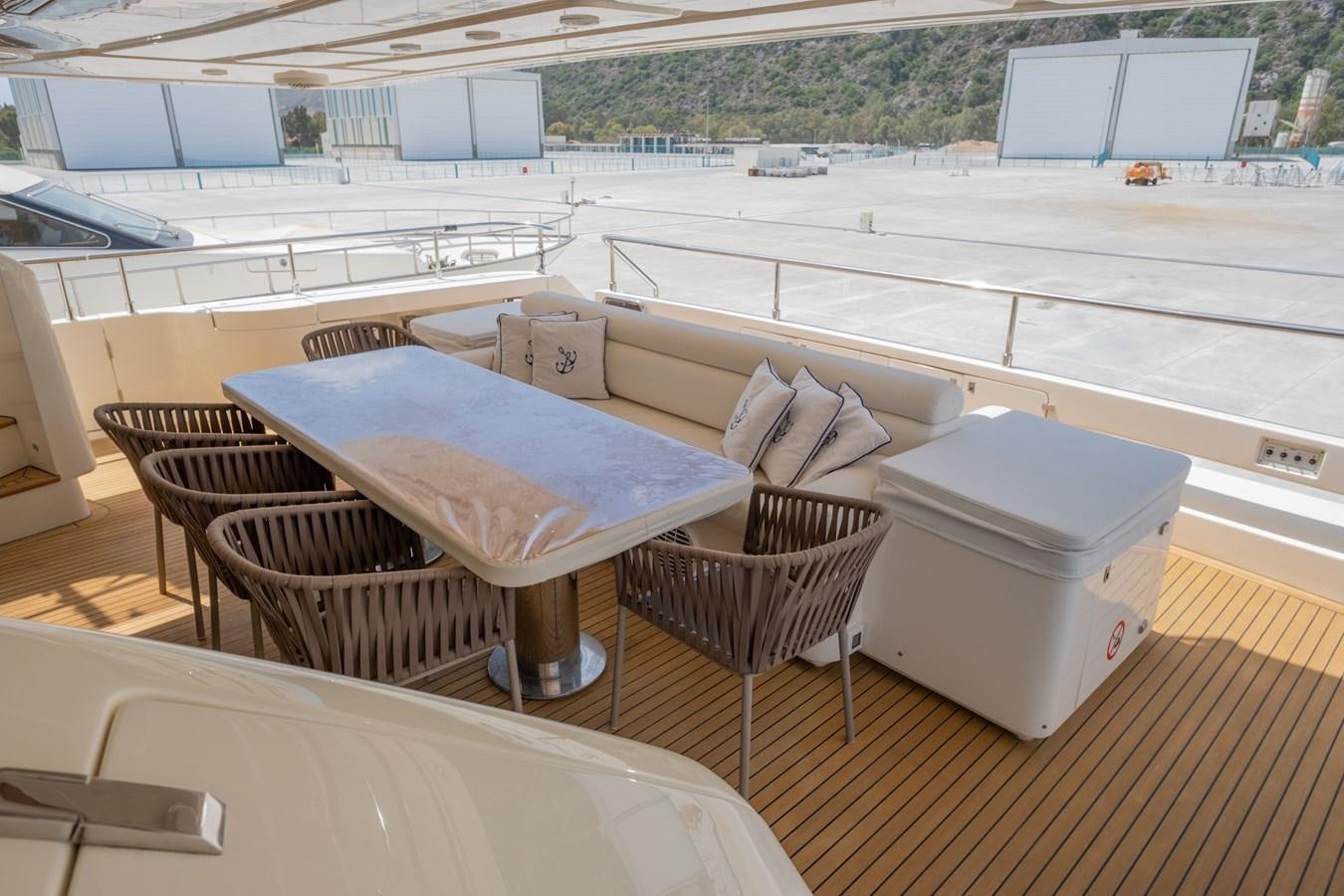 a deck with a couch and a table on it aboard BLEU BLANC Yacht for Sale