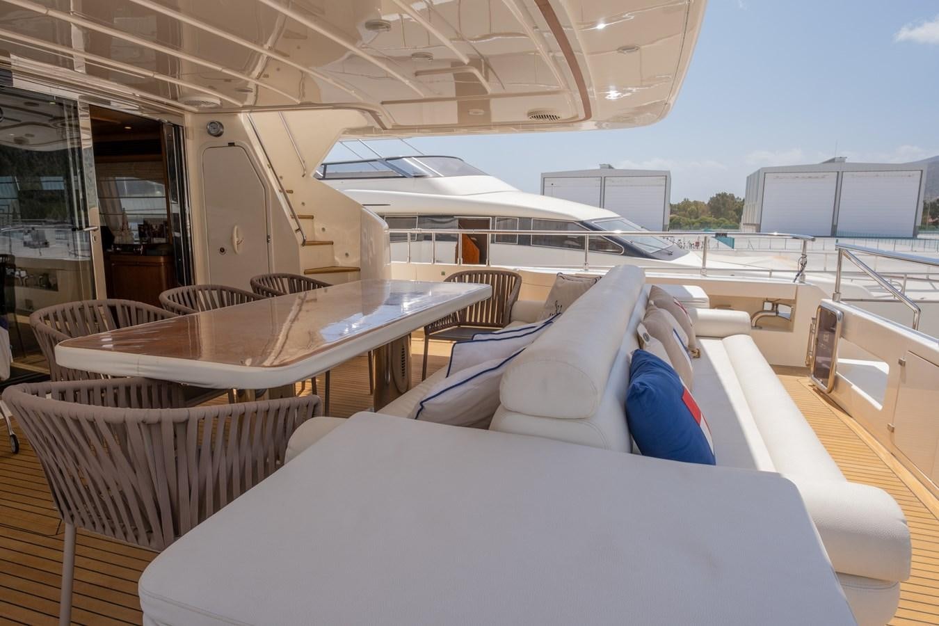 a boat with a table and chairs aboard BLEU BLANC Yacht for Sale
