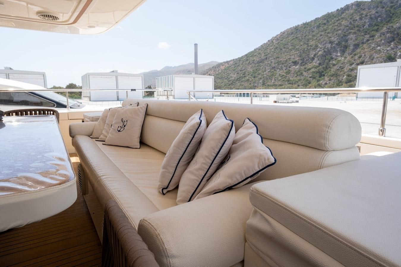 a couch with pillows on it aboard BLEU BLANC Yacht for Sale