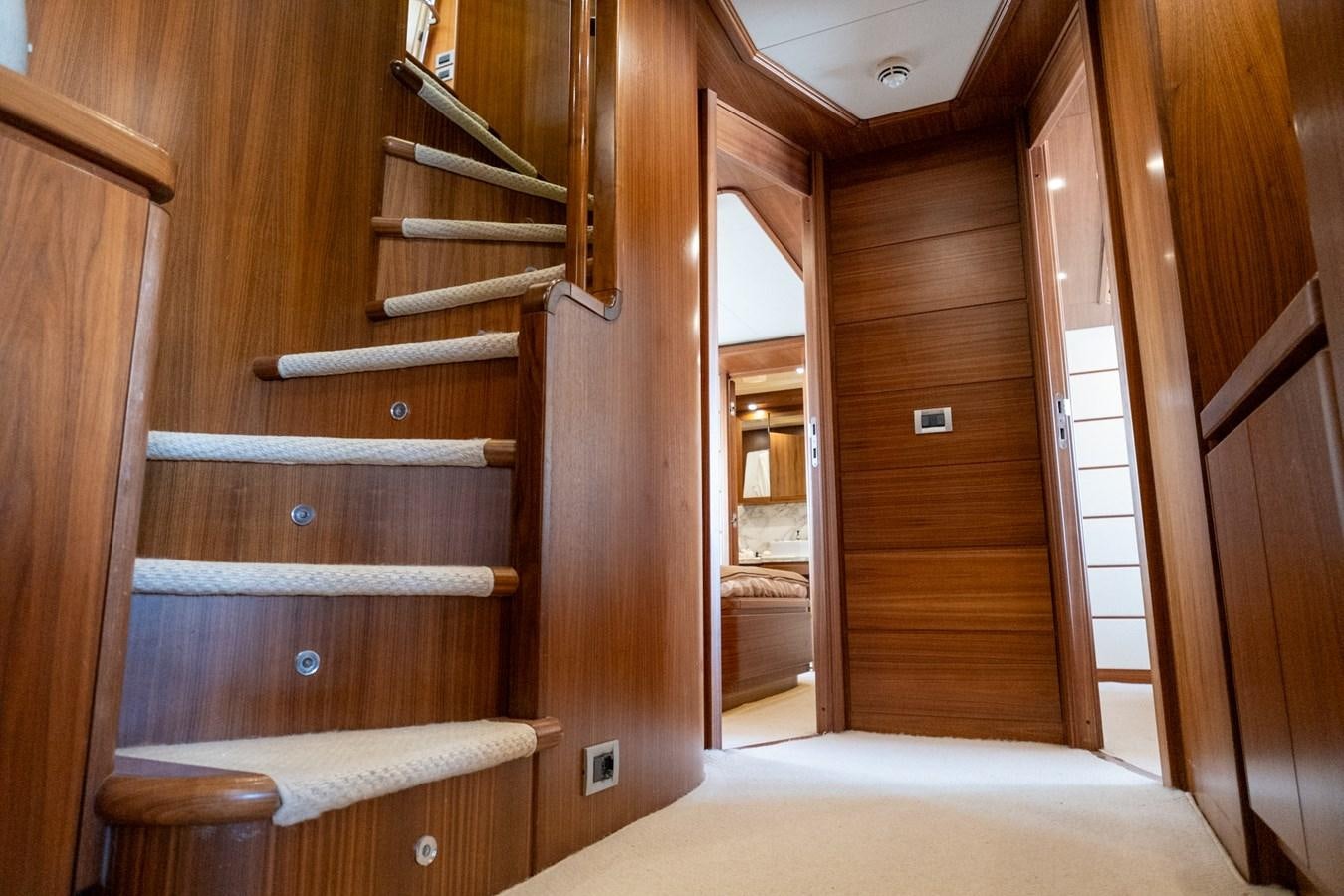 a wooden staircase in a house aboard BLEU BLANC Yacht for Sale