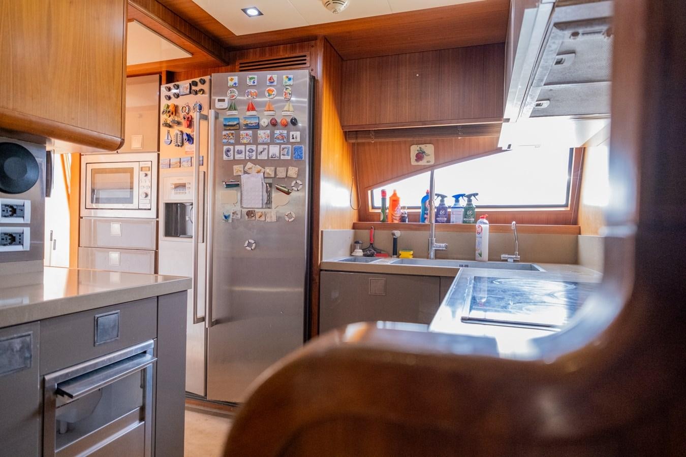 a kitchen with a fridge aboard BLEU BLANC Yacht for Sale
