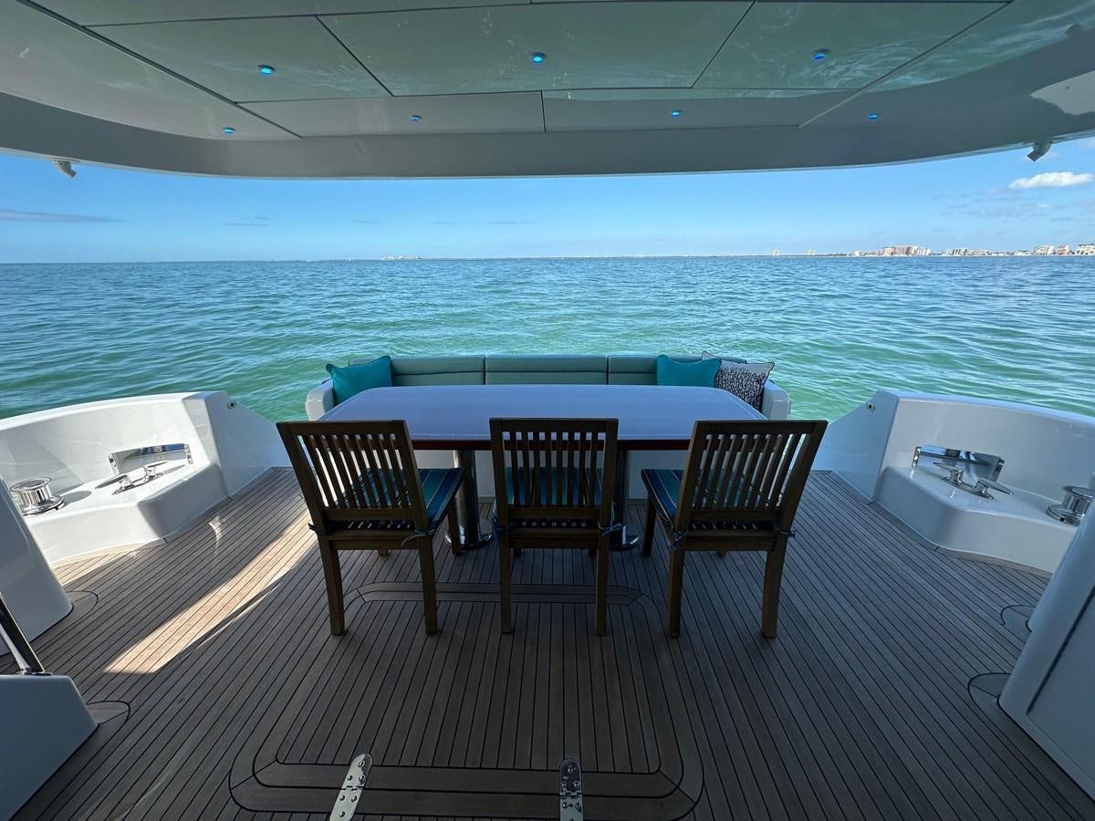a room with a table chairs and a large body of water aboard WATER RODEO Yacht for Sale