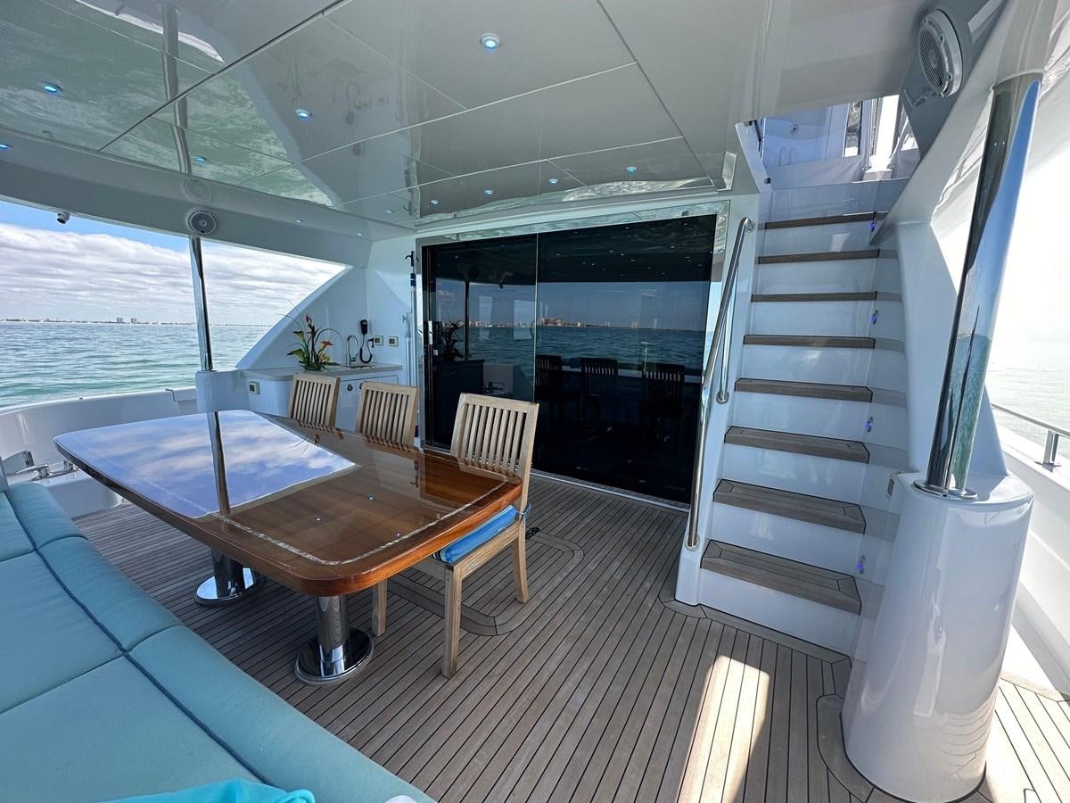 a room with a table and chairs aboard WATER RODEO Yacht for Sale