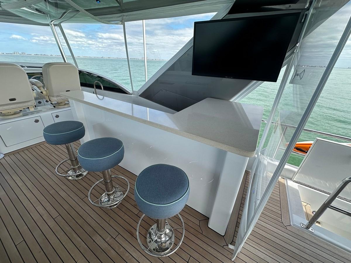 a room with a table and chairs aboard WATER RODEO Yacht for Sale