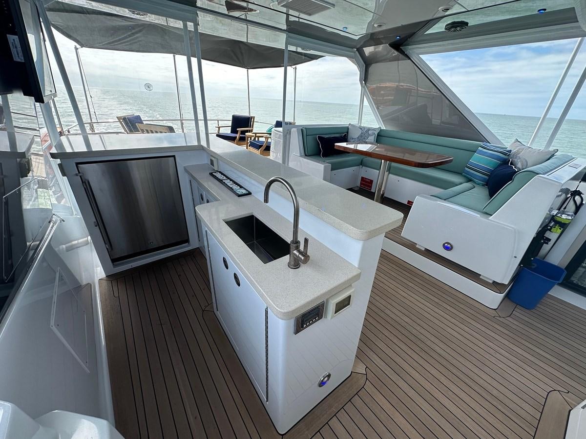 a kitchen with a sink and a large window aboard WATER RODEO Yacht for Sale