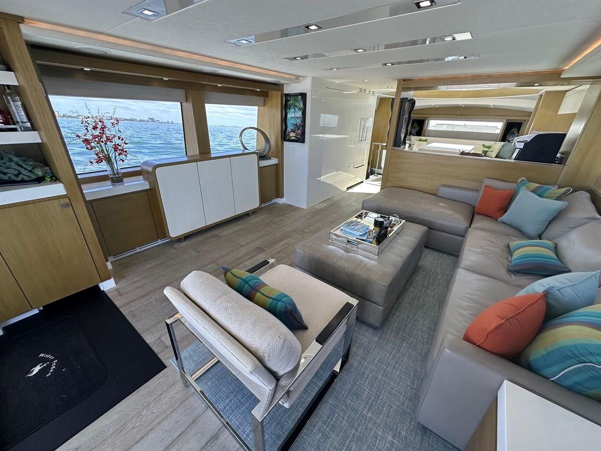 a living room with a couch and a table aboard WATER RODEO Yacht for Sale