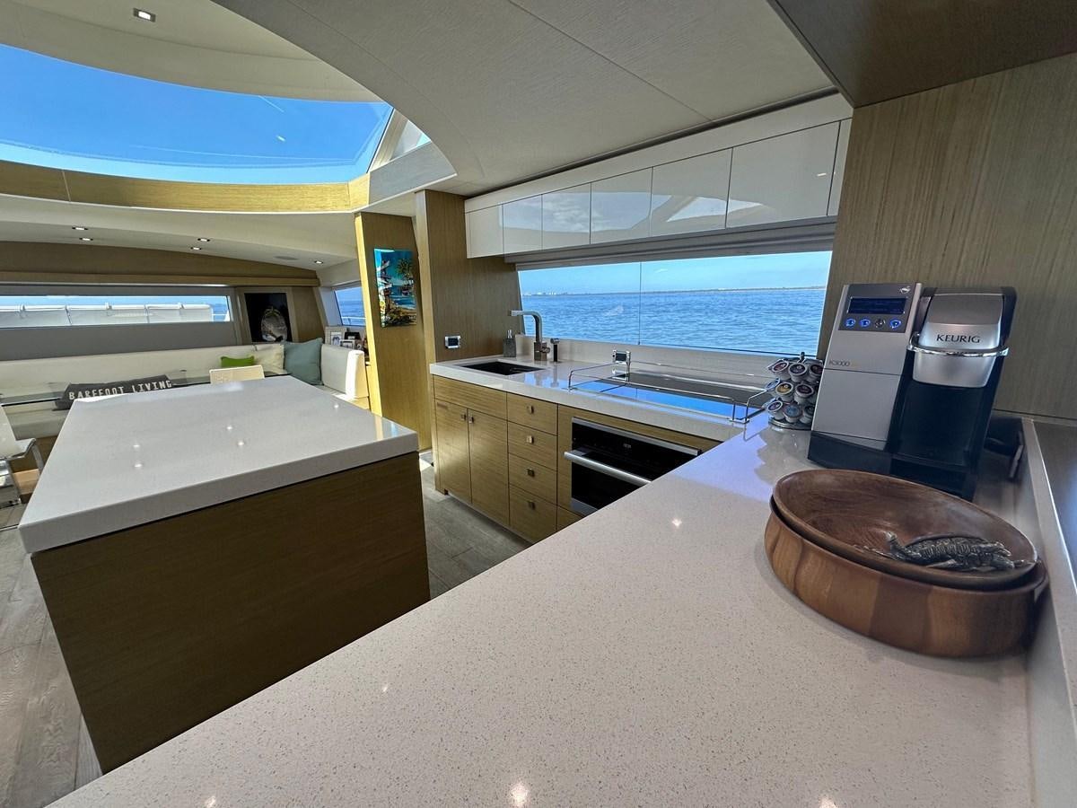 a kitchen with a large island aboard WATER RODEO Yacht for Sale