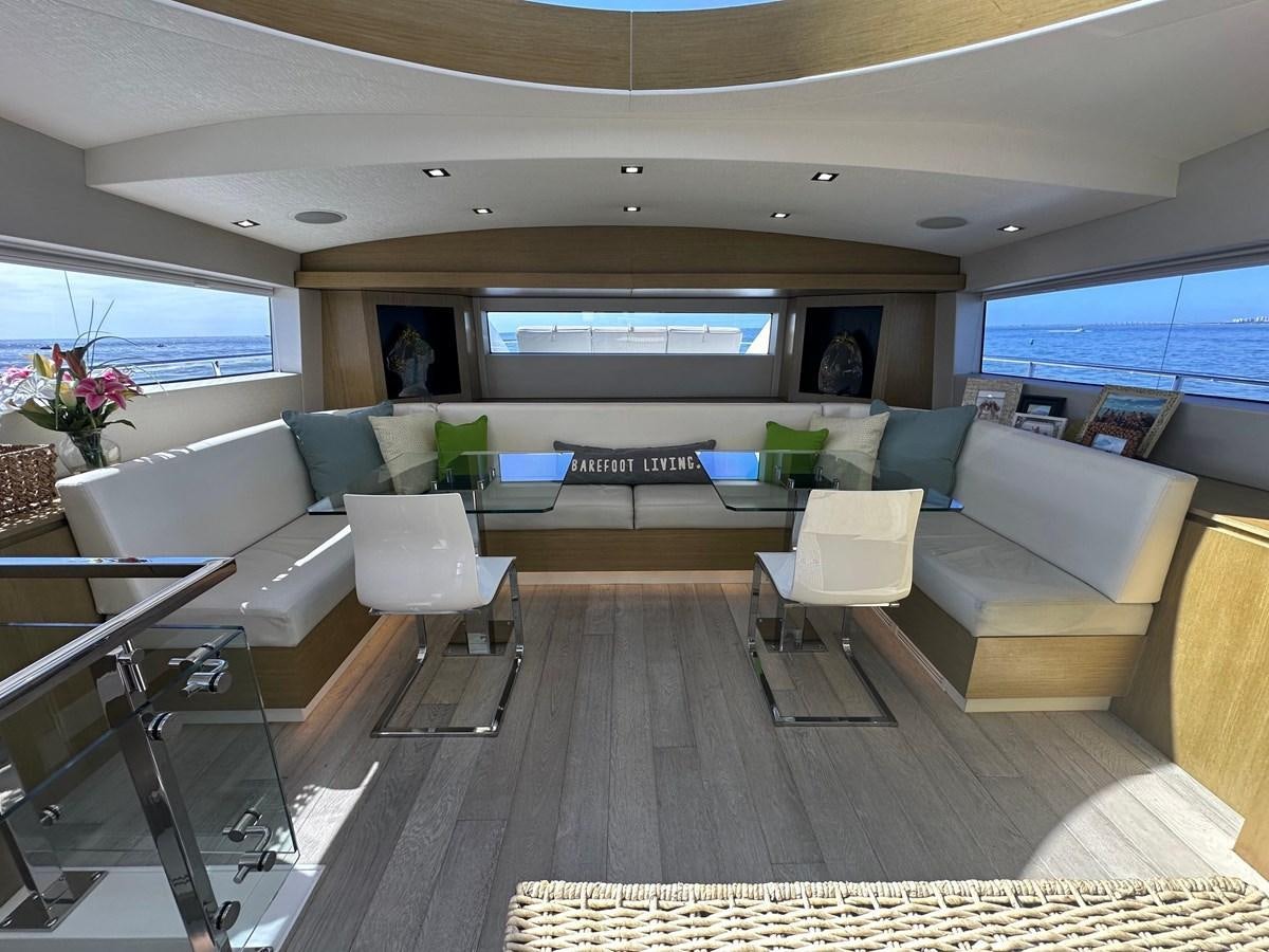 a living room with a large window aboard WATER RODEO Yacht for Sale