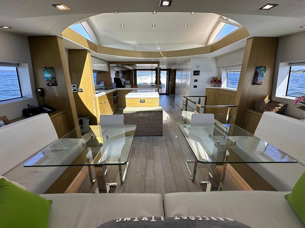 a room with tables and chairs aboard WATER RODEO Yacht for Sale