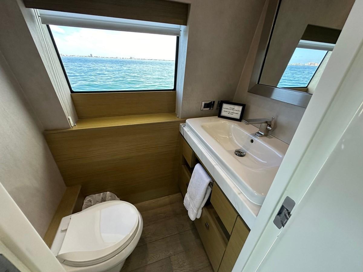 a bathroom with a sink toilet and a window aboard WATER RODEO Yacht for Sale