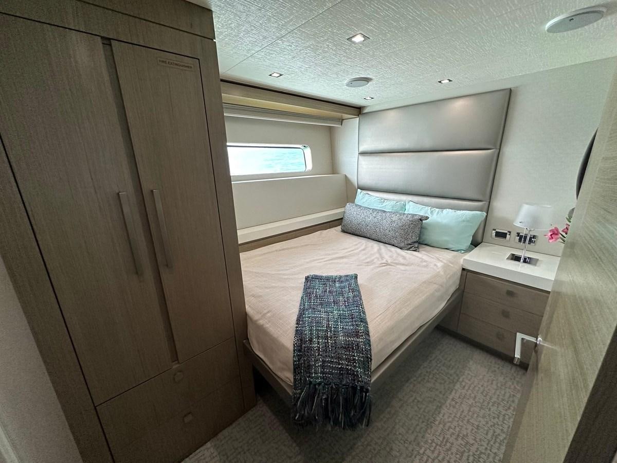 a small bedroom with a bed aboard WATER RODEO Yacht for Sale