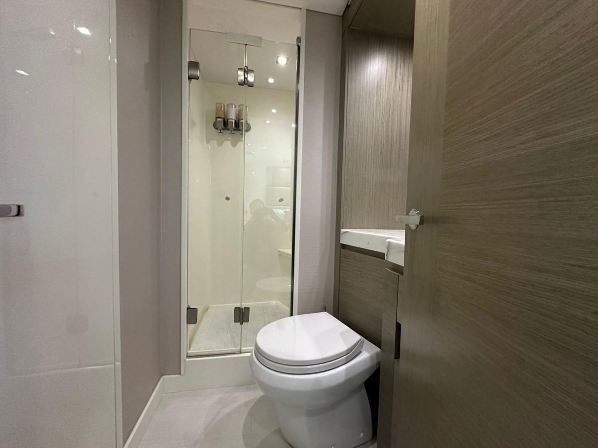 a bathroom with a glass shower aboard WATER RODEO Yacht for Sale