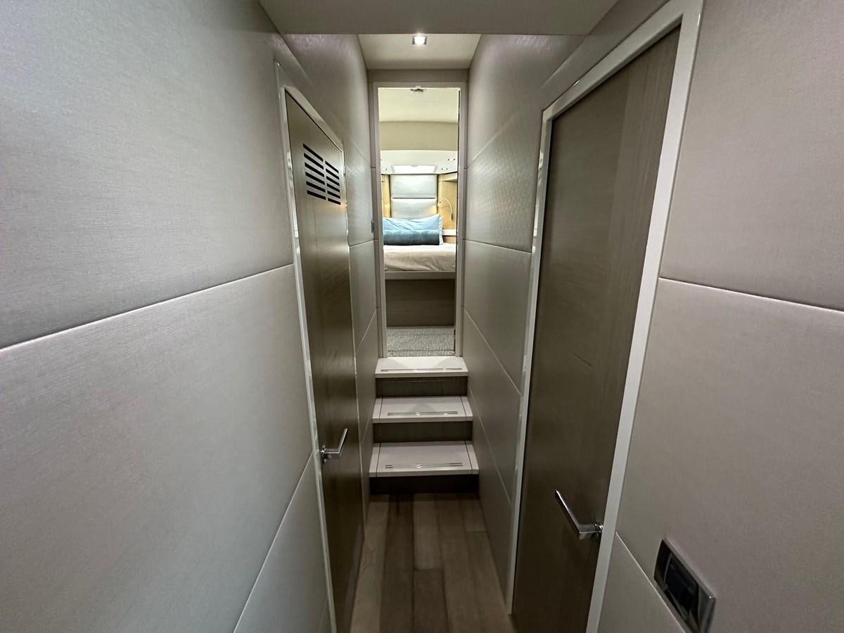 a hallway with a glass door aboard WATER RODEO Yacht for Sale