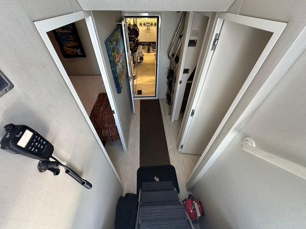 a hallway with a desk and a phone on the wall aboard WATER RODEO Yacht for Sale