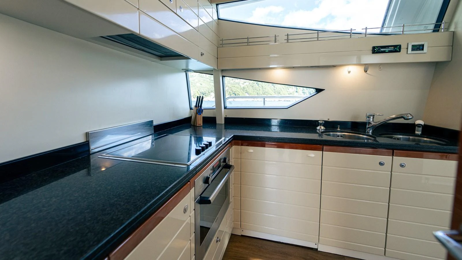 a kitchen with a stove and a sink aboard LADY HELENA Yacht for Sale