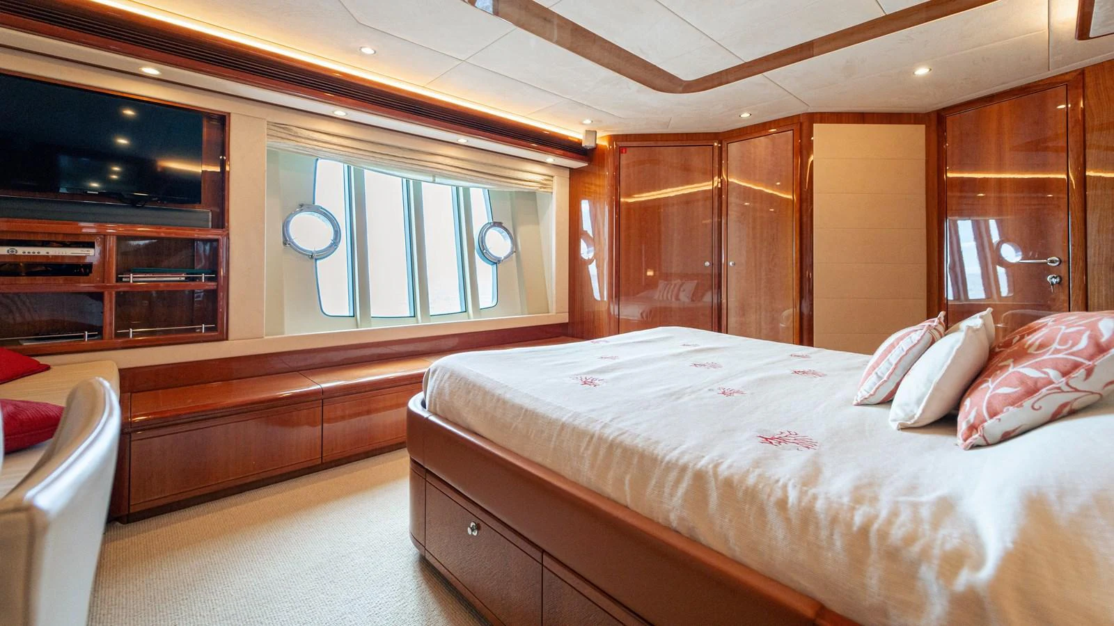 a bedroom with a bed and a television aboard LADY HELENA Yacht for Sale