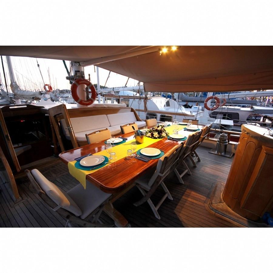 a room with a table and chairs aboard NEMESIS Yacht for Sale
