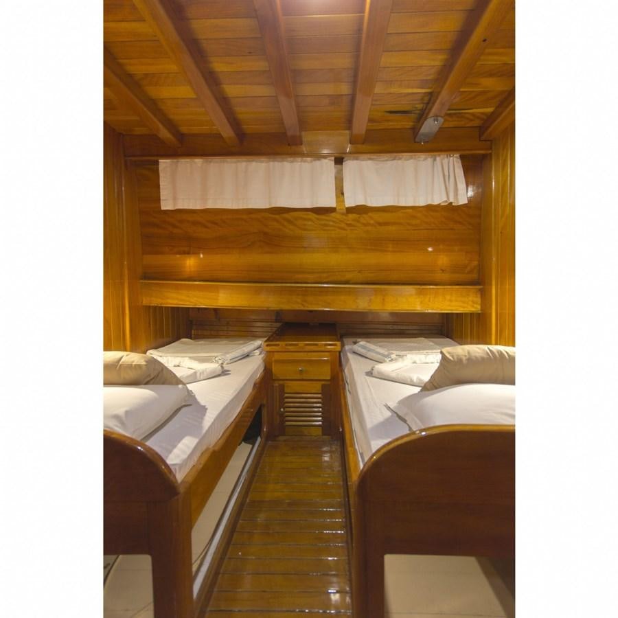 a room with beds and a wood wall aboard NEMESIS Yacht for Sale